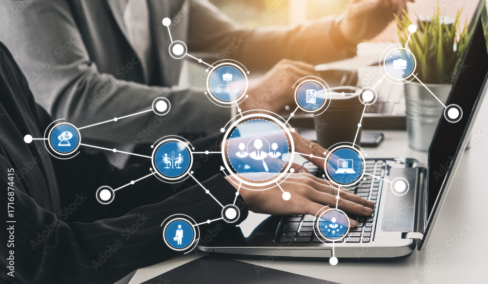 Poster business professionals collaborate at a modern workspace, utilizing a laptop with visual network ico