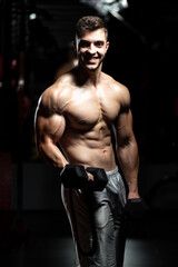 Fototapeta premium Biceps Exercise With Dumbbells In A Gym