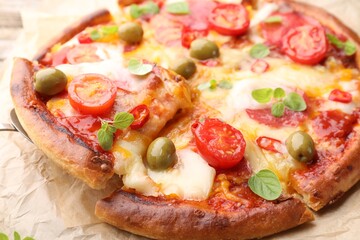 Taking piece of delicious pizza with cheese, tomatoes and olives at table, closeup