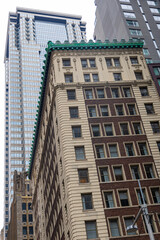 Obraz premium Tall historic skyscrapers rising above Wall Street in Manhattan