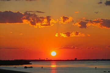 A vibrant sunset glows over Choctawhatchee Bay in Destin, Florida