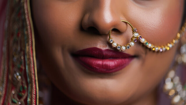 Indian bride close-up, traditional nose ring, elegant bridal jewelry, cultural beauty, Sharad Purnima celebration, red lipstick, festive adornment, feminine grace, ethnic ornament, bridal style