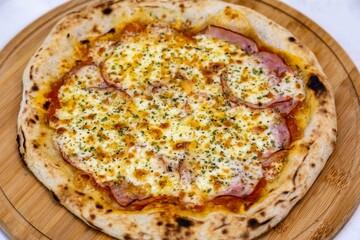 Traditional Brazilian pizza with Canadian pork loin and mushrooms in a rustic, artisanal, long-fermented dough baked in a wood-fired oven.