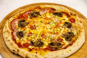 Traditional Brazilian pizza with Canadian pork loin and mushrooms in a rustic, artisanal, long-fermented dough baked in a wood-fired oven.