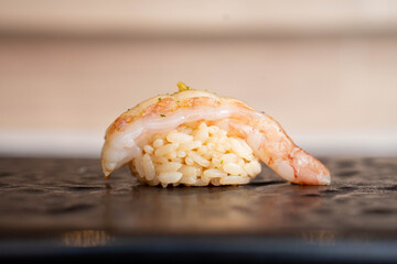 Botan Ebi Nigiri Sushi, Sweet Shrimp Nigiri with Yuzu Kosho, Japanese Omakase Fine Dining, Delicious and Fresh Seafood on a Black Stone Plate.