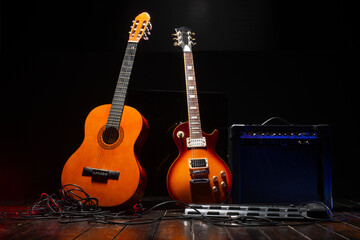 an amplifier and two guitars for concert background music