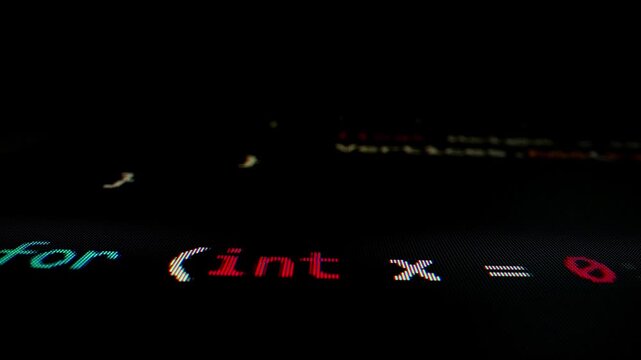 Closeup macro shot movement of coding script moving across LED screen with real-time AI-generated typing, showcasing advanced AI learning in optimization, debug and coding for software development.