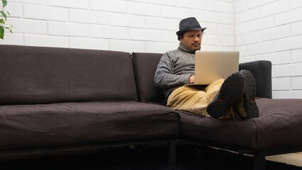 Fototapeta premium casual man wearing a hat working from home