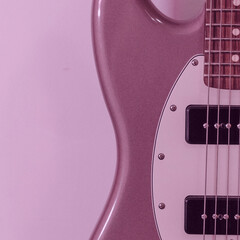Close up of a mauve purple electric guitar body and strings.