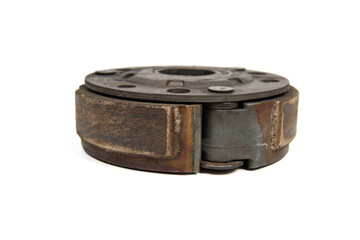 Old rusty metal clutch part isolated on white background, vintage industrial machinery component close up