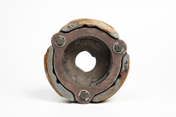 Old rusty metal clutch part isolated on white background, vintage industrial machinery component close up