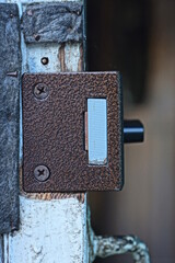 one metal grey brown mortise lock on white wooden door on gray background