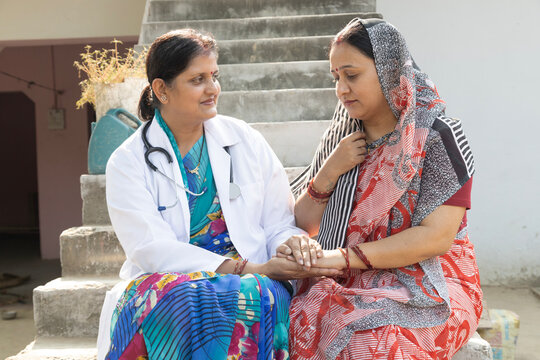 Concept of Indian rural woman health in India. Indian female doctor consulting to unhealth rural woman. Rural India healthcare concept. Protection of cervical cancer in india.