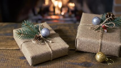 Two rustic Christmas gifts sit by a fireplace. - Powered by Adobe