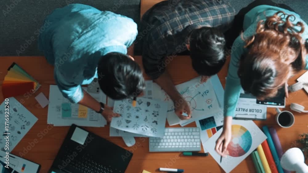 Aufkleber top down aerial view of project manager looking at screen while designer writing idea. smart busines
