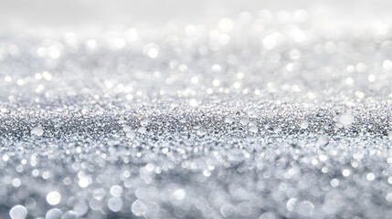 Fototapeta premium A sophisticated backdrop showcases a multitude of shimmering, silver-toned sparkles and glistening water droplets, creating a captivating and elegant visual effect.