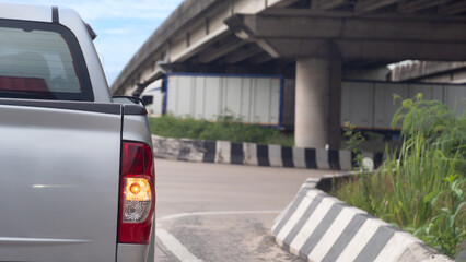 Rear side of silver pickup with turn on right turn signal. Head to the right with your directional...