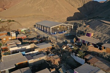 Aerial drone videos of a small fishing cove with boats and desert coastline near Antofagasta, northern Chile