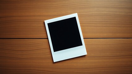 A vintage polaroid frame on a wooden table, captured from an overhead angle in minimalist style.