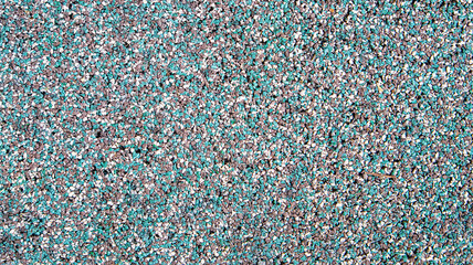 Multicolored pebbles in shades of blue, pink, and grey. Mosaic-like texture ideal for landscaping, decorative paths, and design projects with a natural, vibrant aesthetic.