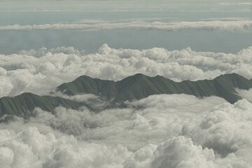 Lush green mountain range peaks emerging from a sea of white clouds