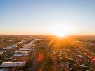 Road dividing residential housing suburb from industrial aera in inland Australian city of Dubbo