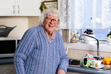 Smiling  portrait of elderly Australian woman inside her kitchen at home in winter