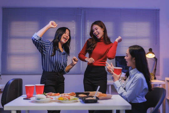 Coworkers celebrating success together after work party