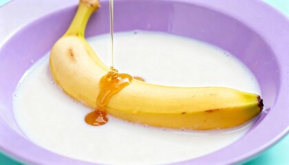 Fresh Banana Dripping with Sweet Honey in Creamy Milk on a Colorful Plate for Delicious Snack and Healthy Dessert Ideas