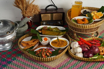 Traditional Malaysian cuisine beautifully arranged with colorful side dishes, fresh herbs, spicy sambal, and decorative presentation that reflects the rich Malay food heritage.
