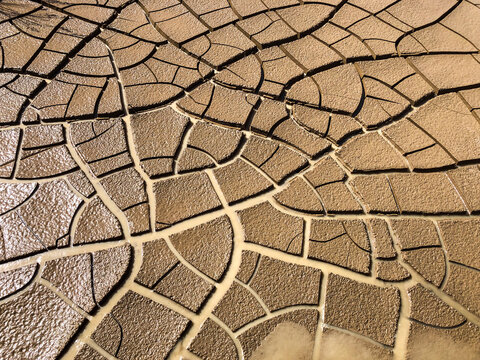 Water returning to desiccated cracked dried out clay earth