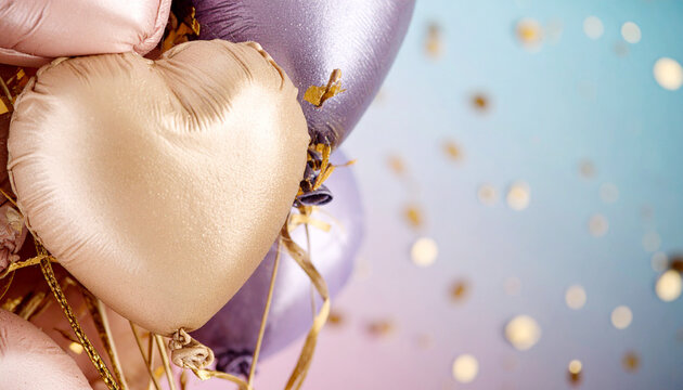 A festive shot of golden heart balloons and shiny lavender balloons, with floating confetti against a soft, blurred pastel background of pink and blue. - Powered by Adobe