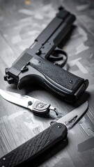 Black firearm and knives on a grey surface
