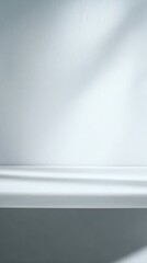 Obraz premium Minimalist white surface with soft shadows and light gradient background