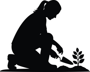 Silhouette of a woman planting a seedling