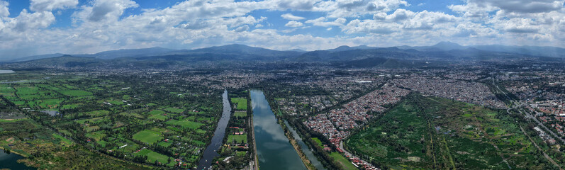 Aerial photograph of Xochimilco ecological zone in Mexico City, a day with clouds and a summer sun over wetlands to south of city
