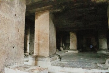 Interior view of the plain stone columns inside Ellora cave 29 or "dhumar lena",ancient rock cut hindu cave temple features massive square pillars