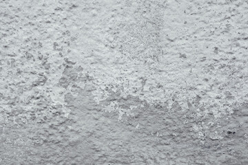 Grungy white concrete wall background with peeling paint and rough texture.