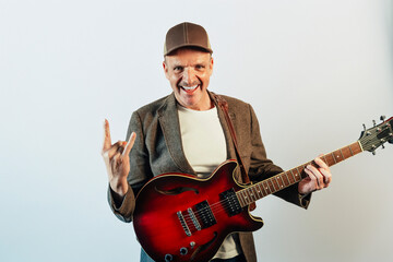man making rock sign with guitar