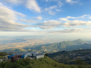 houses on the mountain with stunning view of mountain and cloudy sky