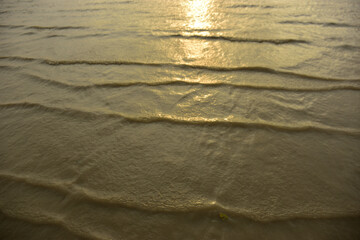 Calm ocean waves forming natural patterns at sunset, symbolizing peace, rhythm, and the beauty of seascape nature photography, perfect for design and backgrounds.