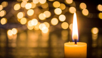 Burning Candle with Warm Golden Bokeh Lights