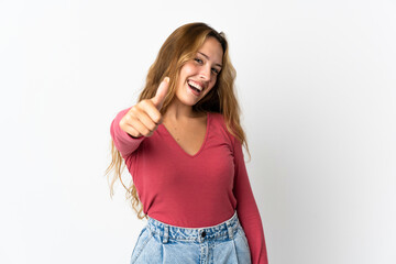 Young blonde woman isolated on blue background with thumbs up because something good has happened
