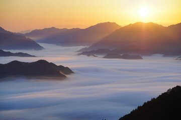 Fototapeta premium Breathtaking sunrise over a sea of fog in the mountains