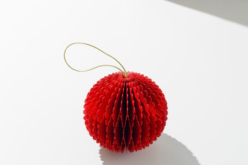 Festive Paper Christmas Ornament, hanging red New Year ball, honeycomb scandinavian decor on light...