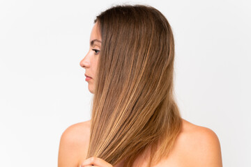Fototapeta premium Young caucasian woman isolated on white background touching her hair. Close up portrait