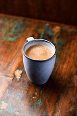 Cup of coffee on rustic wooden background. Soft focus. Copy space	