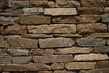 Fototapeta premium Old stone wall texture background Dark brown brick stone masonry close up Rustic stone wall pattern for design