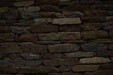 Old stone wall texture background Dark brown brick stone masonry close up Rustic stone wall pattern for design