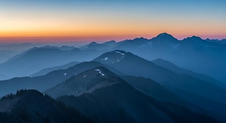 Fototapeta premium Layered mountain ranges at dusk with a gradient sky of orange and blue.